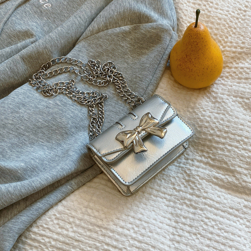 Damen Mini-Handtasche mit schimmerndem Schleifenverschluss