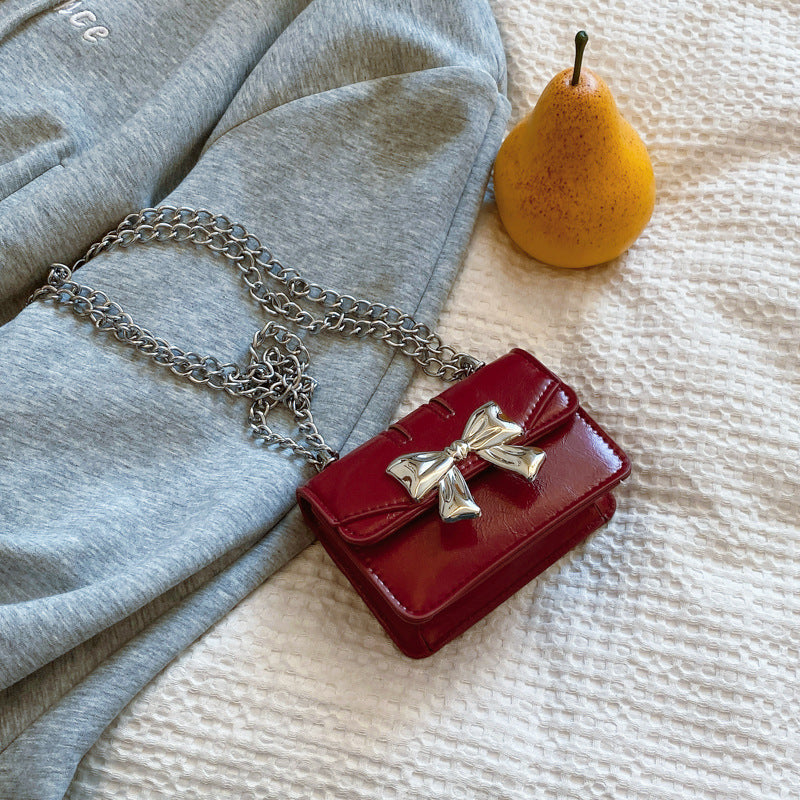 Damen Mini-Handtasche mit schimmerndem Schleifenverschluss